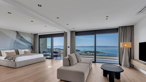 Una habitación de hotel moderna con cama, sofá y una mesita.