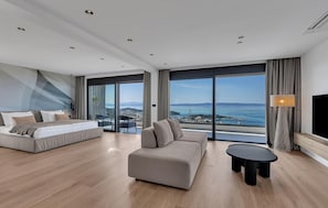 A modern hotel room with a bed, sofa, and a small table. - Luxurious home in Makarska with sauna (Makarska)