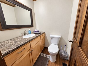 Bright bathroom with spacious vanity, large mirror, and warm wood finishes - Mercer House on Major Snowmobile and ATV Trail (Mercer)