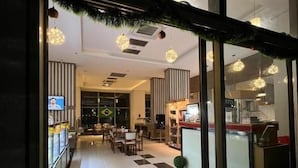 A restaurant with a red sign reading "Feijão Eating" and a checkered floor pattern. - Rio Centro Stay (Rio de Janeiro)