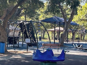 Explore the park's playground, seating area, and shaded pavilion.
