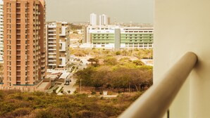 A high-rise building with a view of a cityscape, including other buildings and some greenery. - Charming 1-bedroom apartment in wonderful Barranquilla with AC, WiFi (Barranquilla)