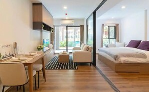 Une chambre d’hôtel moderne équipée d’un lit, d’un bureau et d’un coin salon.