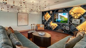 A modern living room with a sofa, coffee table, and a TV wall unit. - Deep Ellum Lux apartment with endless amenities! (Dallas)