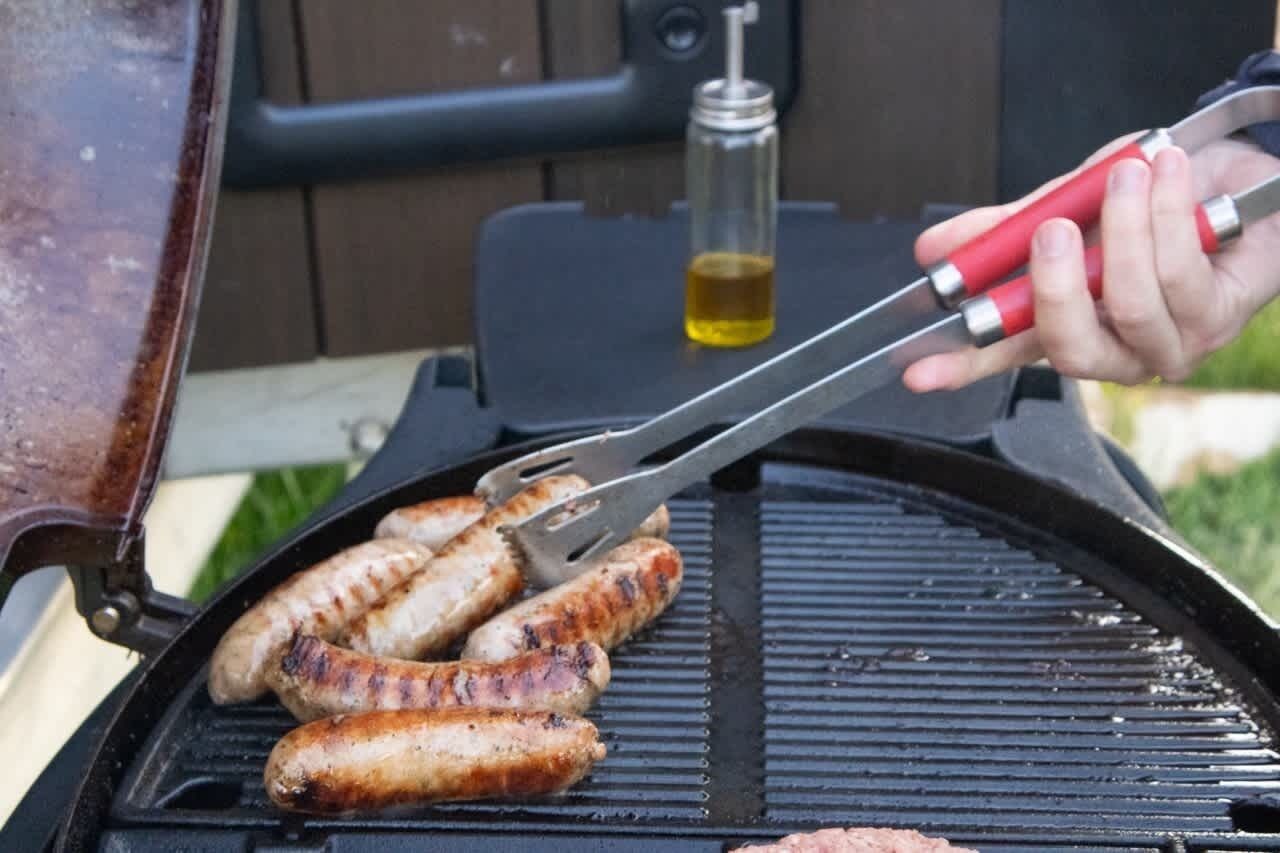 A grill with sausages being cooked.