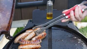 A grill with sausages being cooked.