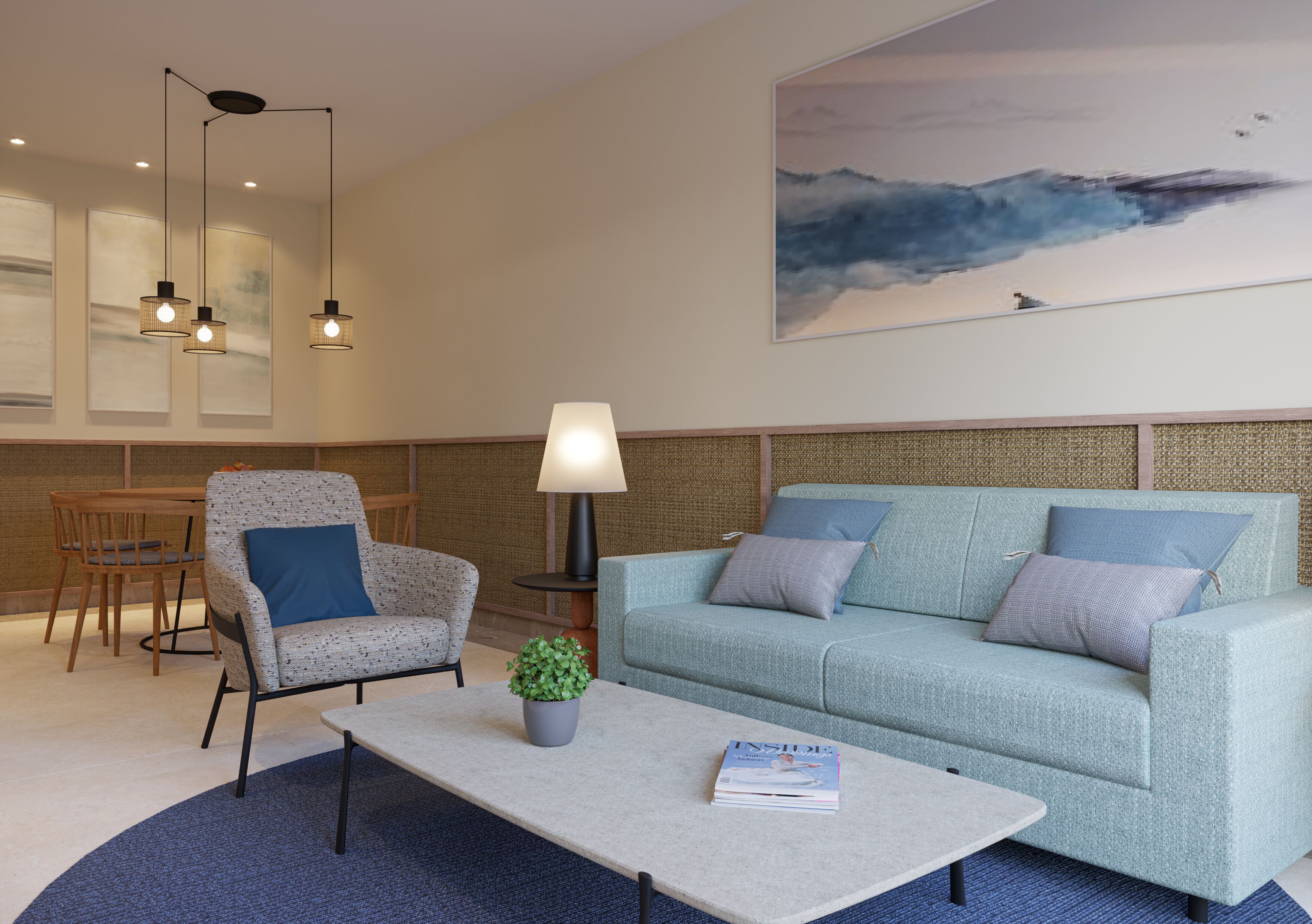 A modern living room with a sofa, armchair, coffee table, and a painting of a seascape.