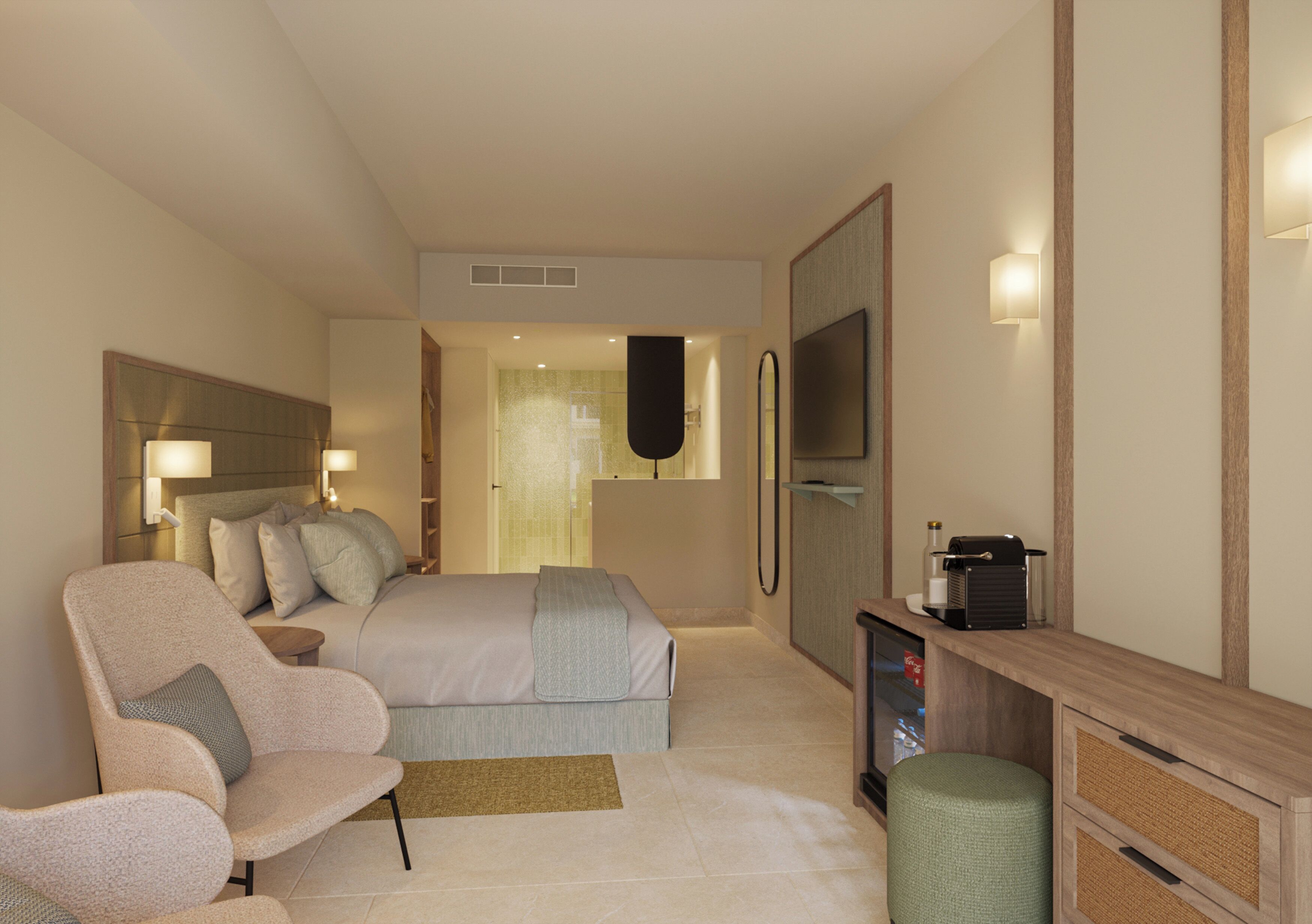 A modern hotel room with a bed, seating area, TV, and a desk with a computer.