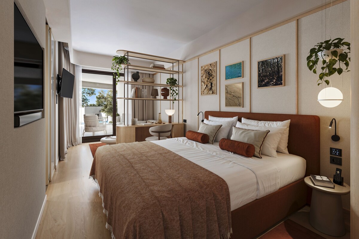 A modern bedroom with a large bed, bedside tables, a desk, and a bookshelf.