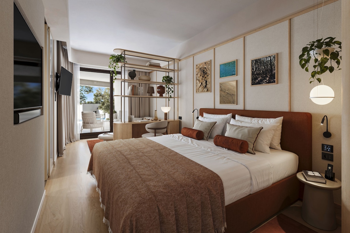 A modern bedroom with a large bed, bedside tables, a desk, and a bookshelf.