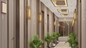 A hallway with a long, polished floor, flanked by vertical wooden panels and potted plants. - Hotel Ramaye - Bhopal (Bhopal)