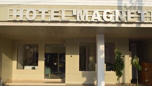 A hotel entrance with the name "HOTEL MAGNET" prominently displayed above the doors. - HOTEL MAGNET - INDORE (Indore)