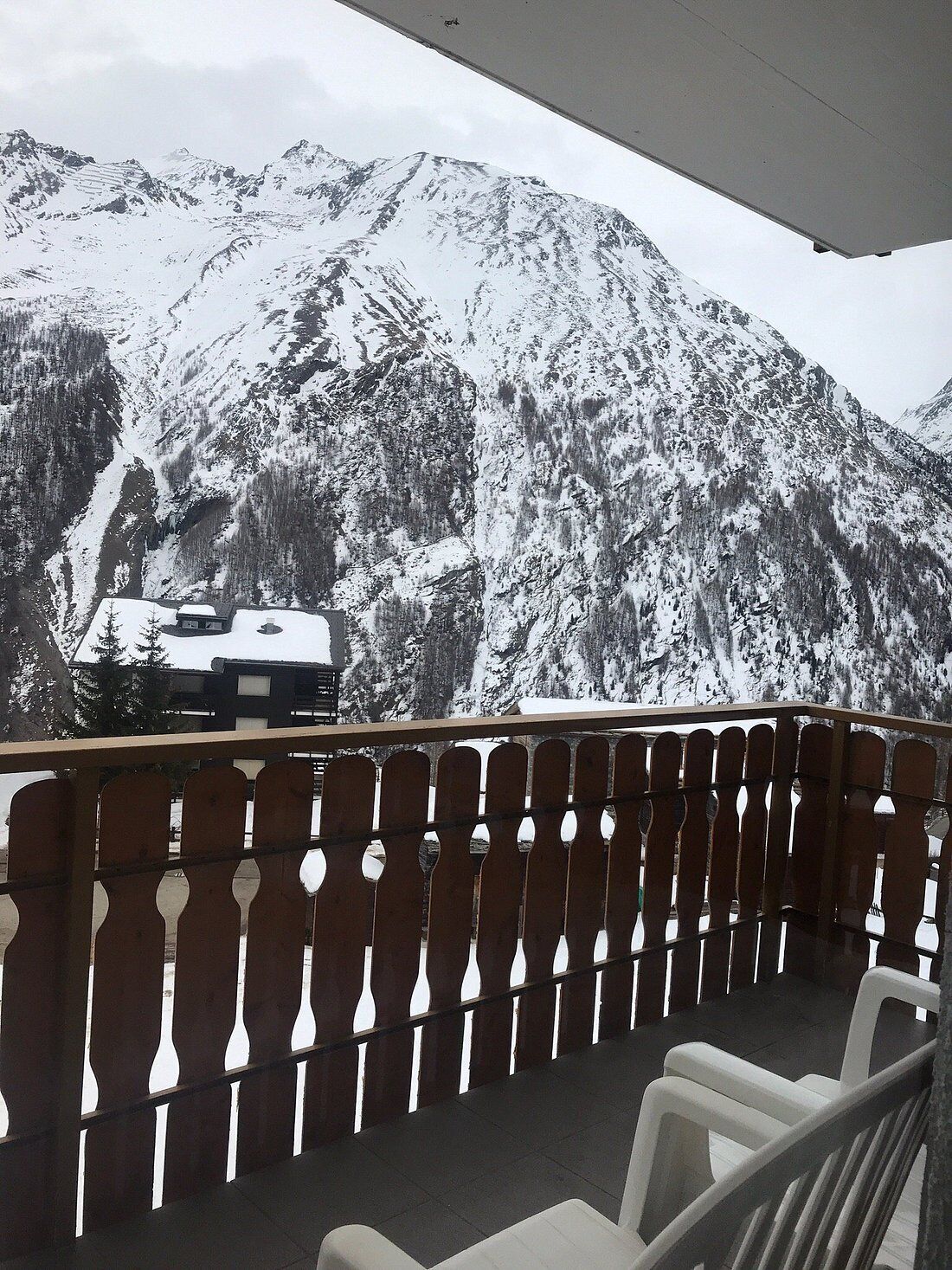 A balcony with a view of snow-covered mountains.