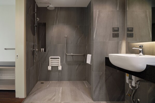 A modern bathroom with a shower, a white sink, and a towel rack. - T2 The Portal Sukhumvit (Bangkok)