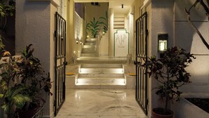 A marble-floored hallway with a staircase leading to a room. - Avaanti Boutique Stay By Avaanti Stays (Udaipur)