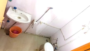 A small bathroom with a sink, toilet, and shower. - Divya Prayag Kumbh Camp  (Karchana)