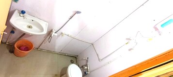 A small bathroom with a sink, toilet, and shower.
