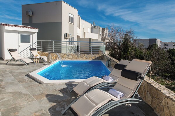 Seasonal outdoor pool, pool umbrellas, pool loungers