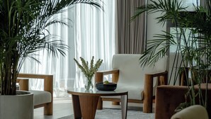 A modern living room with a sofa, armchairs, a coffee table, and potted plants. - Villa Amaluna (Canggu)