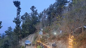 A dirt path with a wooden fence and a car parked on the side. - For Rest Home Shimla  (Shimla)