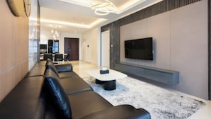 A modern living room with a sofa, coffee table, and TV.