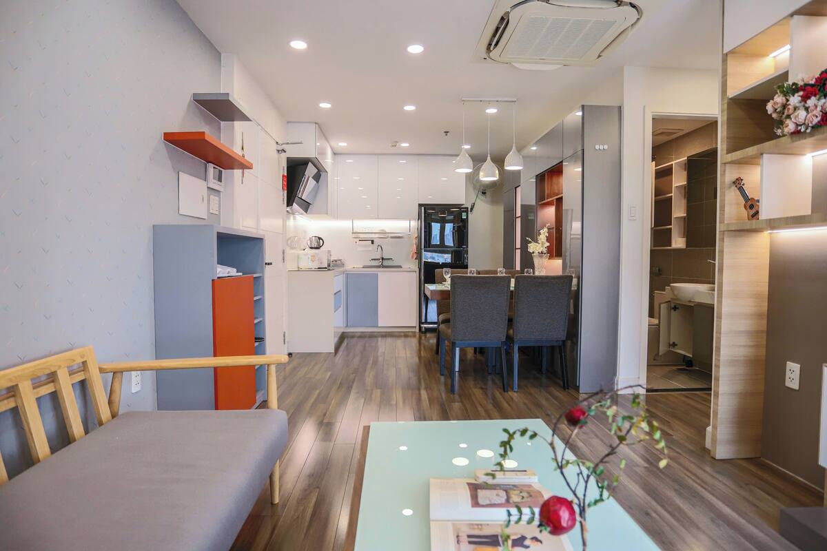 A compact living space with a dining area, kitchenette, and a small seating area.