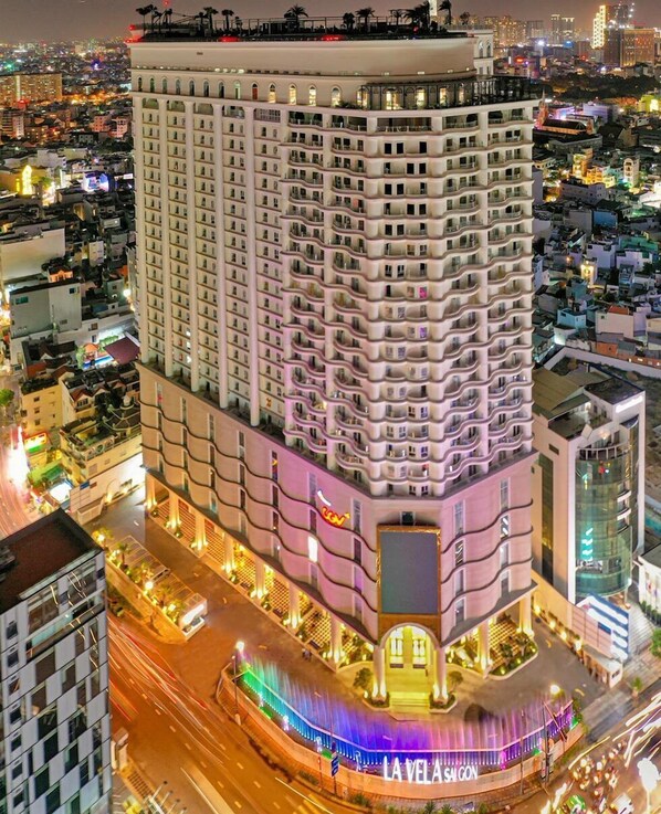 A high-rise hotel with multiple floors, a prominent entrance, and a well-lit facade.