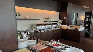 A buffet setup with various food items, including meats, cheeses, and condiments, arranged on a table with a white tablecloth. - LAVilla Osijek (Osijek)