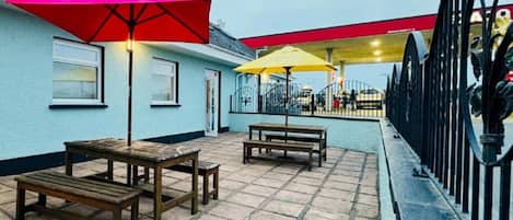 A patio area with outdoor seating and umbrellas.