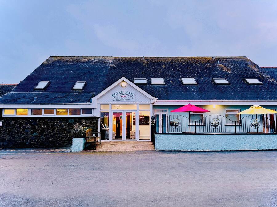 A building with a sign reading "Ocean Haze" and a covered entrance.