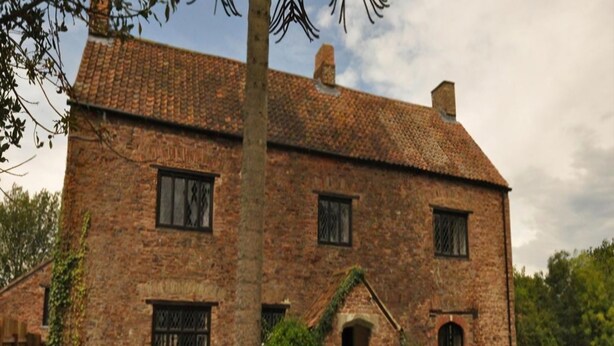 A traditional brick house with a tiled roof, a central entrance, and a small porch. - Langley Inn (Bristol)