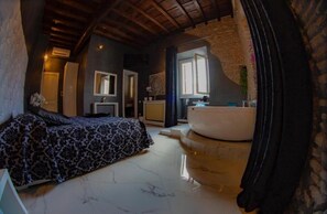 A bedroom with a bed, a large window, and a bathroom with a bathtub. - Rhome Luxury suite (Rome)