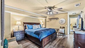 A bedroom with a bed, nightstands, a chair, a dresser, a ceiling fan, and a mirror. - Dwntn, New Hot Tub, Trailer Parking, Dog Friendly (Eureka Springs)