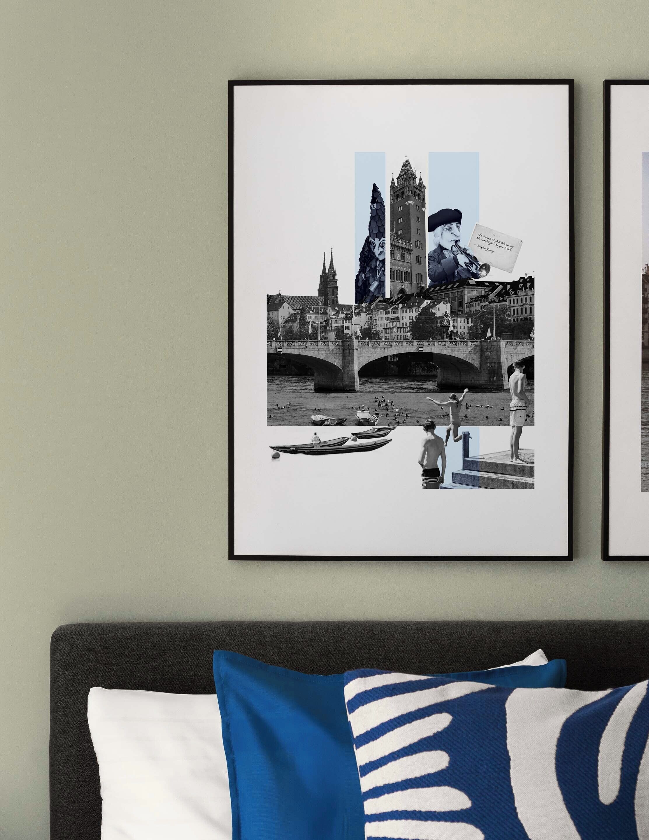 A framed cityscape photograph on a wall, a bed with a dark headboard, and a pillow with a blue and white pattern.