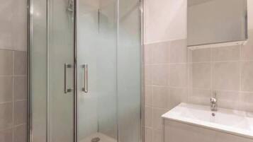 Shower, hair dryer, towels, toilet paper