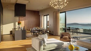 A modern living room with a large window, a dining area, and a kitchen. - 10 Rooms Twin Villas with Amazing views of the Adriatic Sea and Elafiti islands (Dubrovnik)