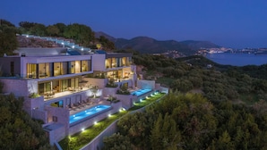 A modern multi-story house with a swimming pool, large windows, and a view of the sea and hills. - 10 Rooms Twin Villas with Amazing views of the Adriatic Sea and Elafiti islands (Dubrovnik)
