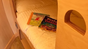 A bed with two books, a wooden headboard, and a small window. - Luxury Glamping Pod at Carrickreagh Bay, Enniskillen (Enniskillen)