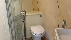 A bathroom with a glass shower enclosure, a toilet, and a sink. - Luxury Glamping Pod at Carrickreagh Bay, Enniskillen (Enniskillen)