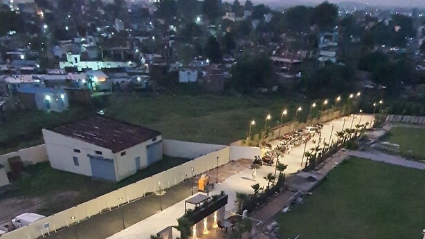A rooftop pool area with multiple seating arrangements and a swimming pool. - Sapphire Blue (Bhopal)