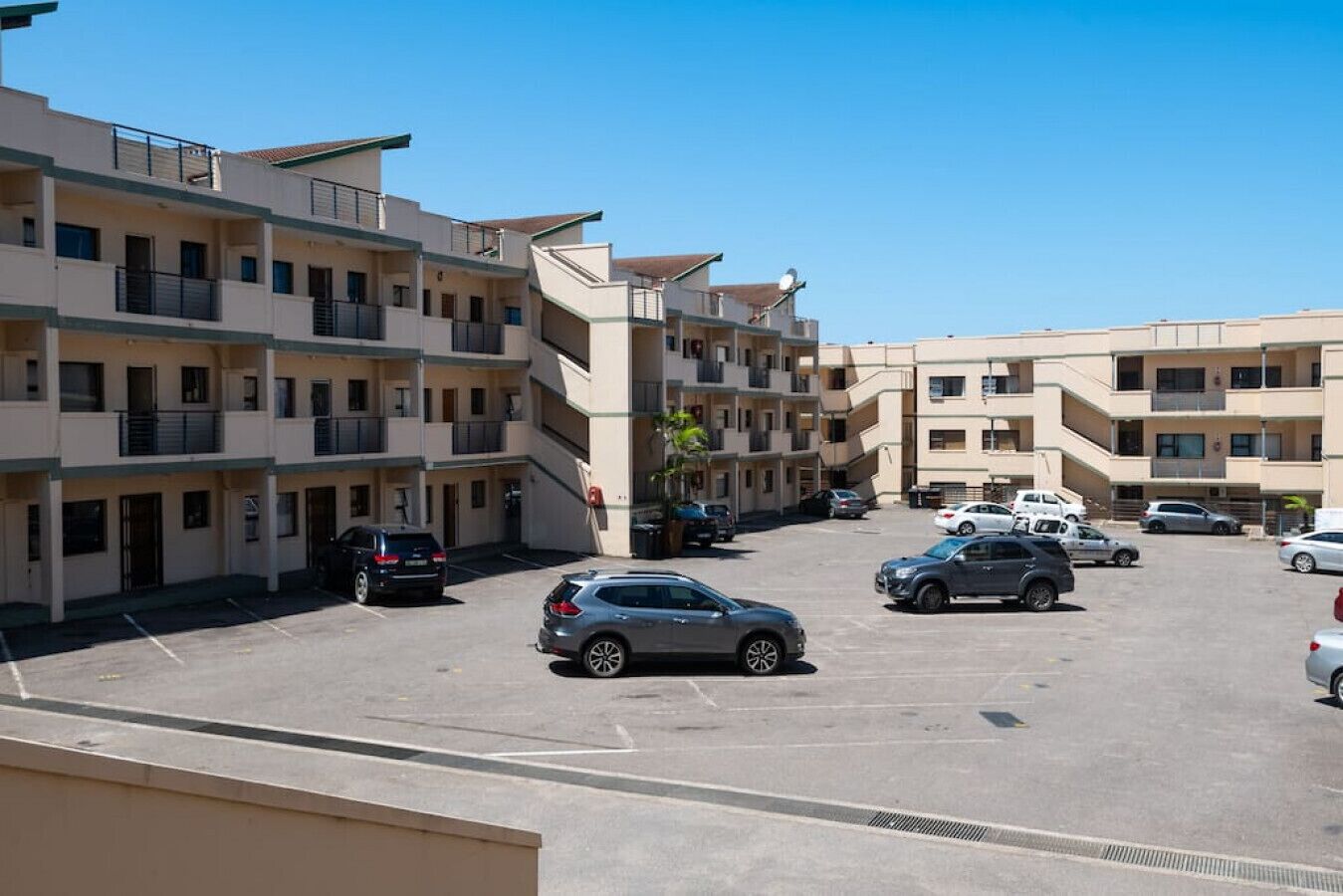A multi-story parking garage with several cars parked.