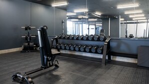 A gym with weightlifting equipment, a bench, and a rack of dumbbells. - Luxury Bellagio 303 (uMhlanga Ridge, KwaZulu-Natal)