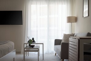 Standard Apartment, Balcony | Living area | 42-inch Smart TV with satellite channels, Netflix, streaming services - Athenian Comfort Apartments (Zografos)