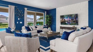 A modern living room with a pool, white sofas, a coffee table, and a TV mounted on a white brick wall.