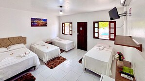 A hotel room with three single beds, a television, a painting, and a door leading outside. - Pousada Estrela da manhã (Barreirinhas)