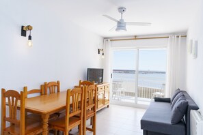 Apartment, 2 Bedrooms, Balcony, Beach View | Living area | Flat-screen TV