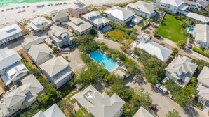An aerial view of a residential area with multiple houses, a swimming pool, and a beach. - Sea La Vie - 30A! Summers Edge in Seagrove Beach, Heated Community Pool! (Seagrove Beach)