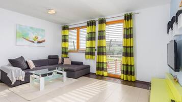 Villa (Four bedroom villa) | Living room | 32-inch flat-screen TV with satellite channels