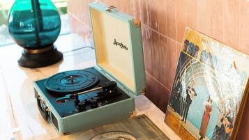 A turntable, a record, and a framed picture on a marble surface.