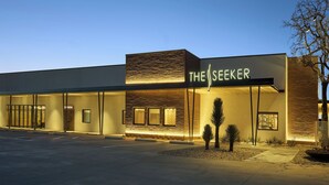 A modern building with a sign reading "THE SEEKER" at night. - Interstate Inn (Stephenville)